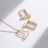 Noi Arch White Huggie Earrings ELKS4184